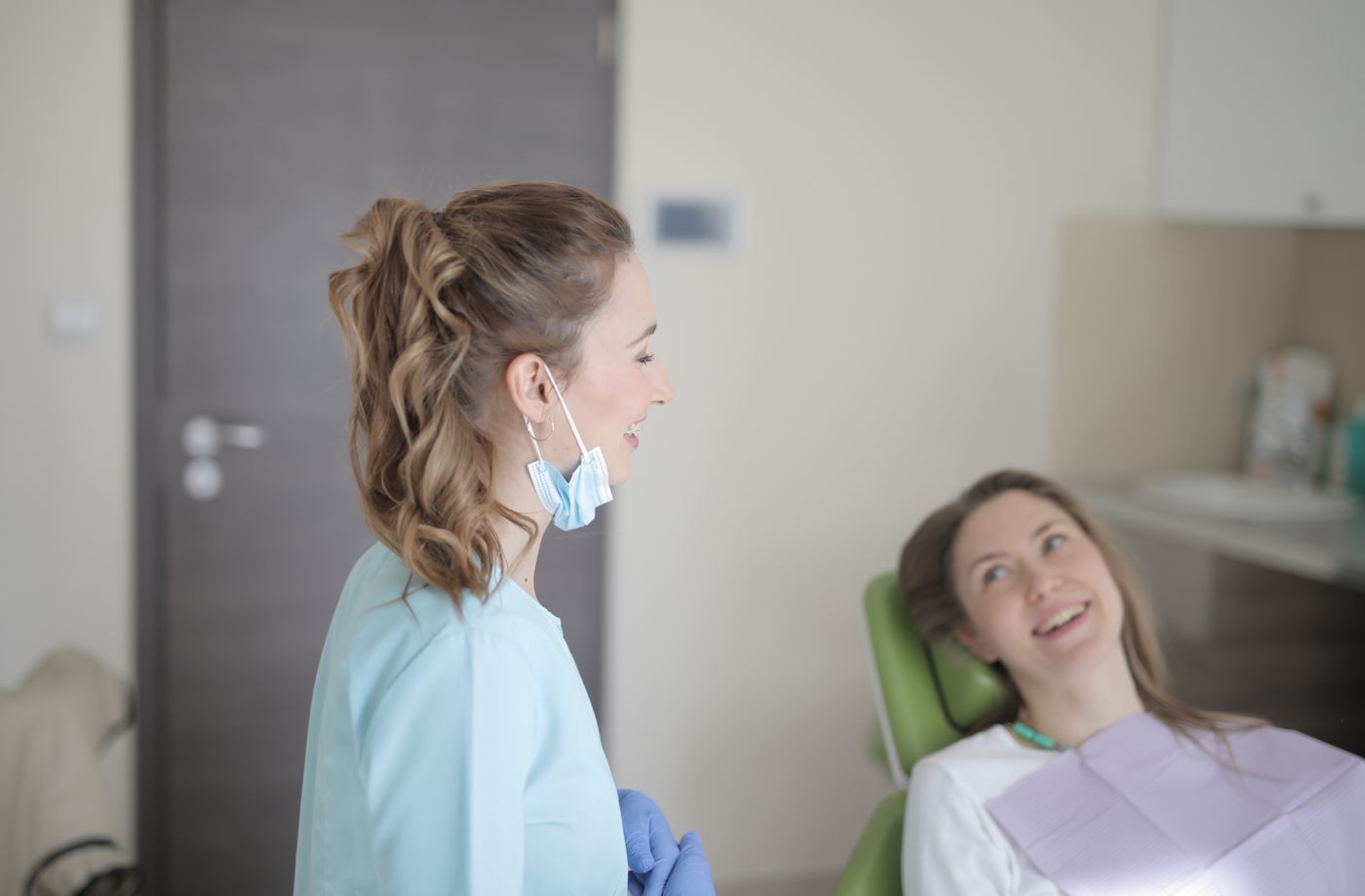 Friendly dentist consulting with a patient in a modern clinic
